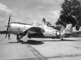 A Republic P-47B Thunderbolt, tail #227738, on pavement at an airbase in in Burma during WWII. P-38 #423800 is behind.