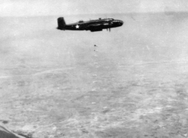 B-25 dropping line of bombs over SW China, French Indochina, or Burma, during WWII.  22nd Bombardment Squadron.  Image from Francis E. Davis.