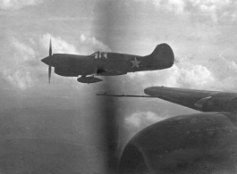 View from B-25s of the 22nd Bombardment Squadron in flight over SW China, Indochina, or Burma during WWII--Happy for the rare escort by P-40s (with external fuel tanks to extend range).