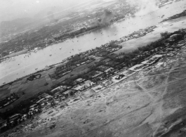 Aerial view of bombing of Tourane, Indochina, by 22nd Bombardment Squadron in the CBI.
