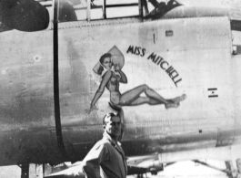 Flyer standing with B-25 "MISS MITCHELL," in CBI during WWII.