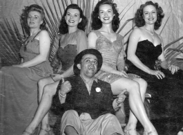 Ladies and tramp of a USO show in Gushkara, India, during WWII.