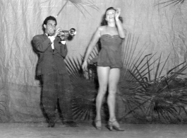 Dancing at a USO show in Gushkara, India, during WWII.  The boxes in front of the band players are labeled 748th ROB (748th Railway Operating Battalion).