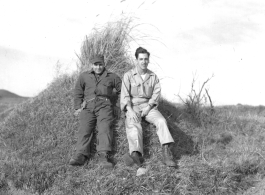American flyers exploring at Chanyi (Zhanyi), during WWII. They are likely resting on a grave mound.