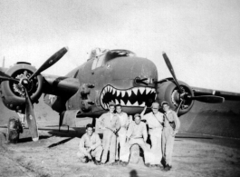 491st Bombardment Squadron personnel with shark-mouth B-25 bomber inside tidy revetment in China: Peterson, unknown, Konkolics (?), Larry Johnson, unknown, Silvernail (?)