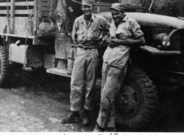 American GIs and transport truck roadside in the CBI during WWII: Charles Bates and Nic Dekker.