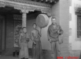 GI poses with monks or trainees at a Lamist temple in northern China during WWII.