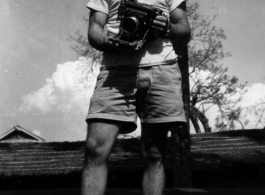 Richard C. Barnhard poses with camera in hand.  Photos taken by Robert F. Riese in or around Liuzhou city, Guangxi province, China, in 1945.