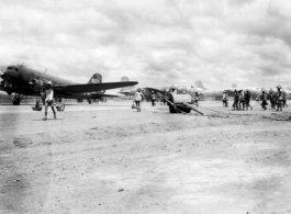 Runway with workers, hand-pulled roller, and airplanes in busy profusion, on the US base at Liuzhou, Guangxi province, China, in 1945.