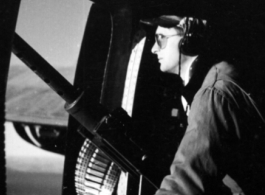 A gunner keeps lonely vigil at the waist gun on a B-24.  From the collection of Hal Geer.
