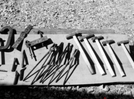 Tools laid out, possibly for sale.  In Guangxi, probably Guilin.  From the collection of Hal Geer.