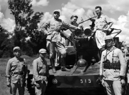 Chinese crew and American GIs aboard Chinese armored vehicle or tank pose for a photo. The vehicle was likely out on a large scale military exercise.  From the collection of combat photographer Eugene T. Wozniak, 491st Bomb Squadron.