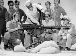 An American instructor explains the use of a machine gun to Chinese troops.