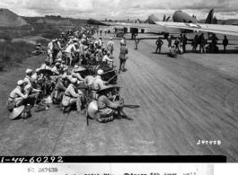 Troops of the 200th Div., Chinese 5th Army, wait at the loading point of the Yunnanyi airbase, China.