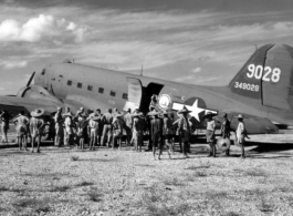 A C-47 (tail #349028) of the Air Transport Command (ATC) on the ground with Chinese laborers in the foreground.
