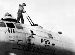 Sgt. Calvin Brown, Kimball, Minnesota, cleans the upper forward guns of the 20th Bomber Command Boeing B-29 Superfortress "Sister Sue".  China.  40th Bomb Group.