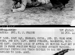 At 52nd Army HQS, Yenshan, China, 2nd Lt. Wang Mong Chien, 2nd Division; Capt. Merle Foraker, Barberton, OH.  The Capt. changes angle of antenna on British B-48 set for use in prone position while Chinese student watches. 