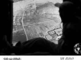 Homeward bound...through open door (which has been removed to facilitate unloading cargo on air dropping mission over front lines) crew look on mountainous terrain and rice paddies enroute to base at Yunnanyi, China.  Photo by T/4 Clayton, 21 June 1944