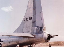 A B-29 bomber, tail number 26340, under maintenance, with a Chinese soldier standing guard, in the CBI.