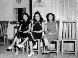 Three Chinese women wait for American servicemen to come pay for a dance at a dance hall in the CBI.