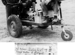 Three gentlemen, Ed Nelson (Bad Axe, Mich), Sgt. Norton G. Stubblefield (Dallas Texas), and 1st Lt. Charles J. Jantzen (Seattle, Washington) with the self-propelled battery cart they have built from spare parts and salvage.