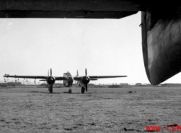 A P-61 Black Widow framed by the tail of another P-61 China. During WWII.