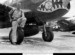 Lt. Col Richard Triber standing before the P-40 "Little Richard."