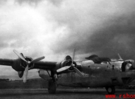 A B-24 in the CBI, with heavy storm clouds overhead.