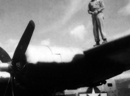 An American standing on a wing of a B-24 in the CBI.