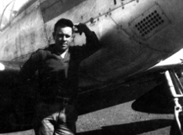 An American serviceman stands next to a P-51 fighter named "Toni".