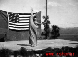 During a USO show at an American airbase Betty Yeaton performs for the service men. October 1944.