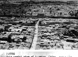 During WWII, this aerial view of Kunming, China, shows the wall and West Gate.  The street running through center of picture is Sui Ching Road.  6/21/1945