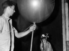 A balloon being filled with helium or hydrogen, probably as part of some kind meteorological measurement, during WWII in the CBI.