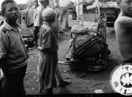 September 27, 1944  During WWII, arms and ammunition wait on the siding at Liuchow as the railhead is jammed with refugees fleeing the Japanese march on Kweilin (Guilin).