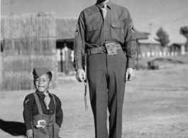 "Little Tiger Joe", well known to the 14th Air Force stationed in China, on the drill ground at 14th Air Force Headquarters with 1st Sgt. Robert Duerson of the 907th Engineers Headquarters Company, in the CBI during WWII.