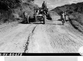 Pvt. Thomas J. Gardner, Georgetown, Ky., road patrol operator of the Burma Road Engineers, grades part of the road west of the Salween River.   Burma, 10/1/1944. During WWII in the CBI.  Signal Corps Photo by Tec 5 C.L. Kocourek.