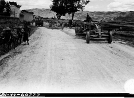 September 29, 1944, Burma Road Engineer's road grader working on the Burma Road and Chinese civilians look on.