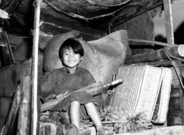 A refugee child rides a cart near around either Liuzhou or Guilin during the evacuation before the Japanese Ichigo advance in 1944, in Guangxi province.