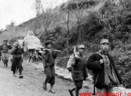 Refugees carry loved one while fleeing around either Liuzhou or Guilin during the evacuation before the Japanese Ichigo advance in 1944, in Guangxi province.