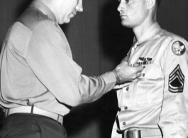 Tech. Sgt. Ora W. Seal, son of Mr. and Mrs. W. h. Seal of Fruita, is shown receiving athe Distinguished Flying Cross and the Air Medal from Lt. Col. John. E. Carmack, post executive officer, at a ceremony held recently at Truax Field, Madison, Wisconsin.