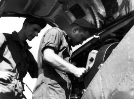GIs change film on an F-5 (a reconnaissance version of the P-38) in the CBI during WWII.