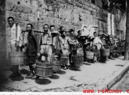 Local citizens lined up with buckets to collect water at Chongqing (Chungking), China, during WWII.