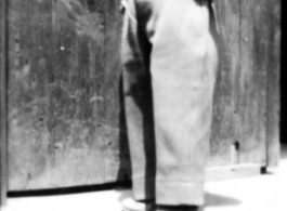 The Chinese child nicknamed "Little Tiger Joe" posing in doorway, during WWII.