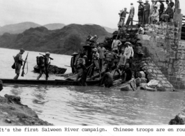 Chinese troops cross walkway (actually a long flat bottom boat) above water en route to Burma-China border front lines of the Salween River Campaign in 1944.  Photo from T/Sgt. Syd Greenberg.