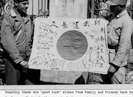 An American and a Chinese soldier show a  captured Japanese Good-Luck Flag  (寄せ書き日の丸) collected on the battleground in the CBI during WWII.  US Army Signal Corps Photo.