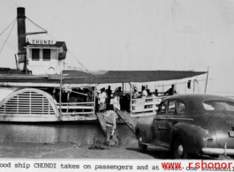 The boat "CHUNDI" takes on passengers and one automobile for travel on an Indian river during WWII.