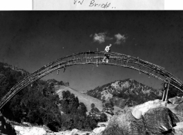 Sgt. Bud Baldwin on Monkey Bridge, China, near Burma border, during WWII.  Photo by Syd Greenberg.
