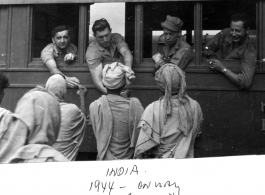 GIs in train from Bombay to Calcutta in 1944, talk to local men in India.  Photo by Syd Greenberg.