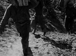 GIs carry 10 lb ration boxes on a trail, possibly after airdrop in Burma or SW China