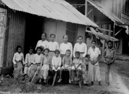 A Burmese family outside their home at Namti, Burma, 1944.